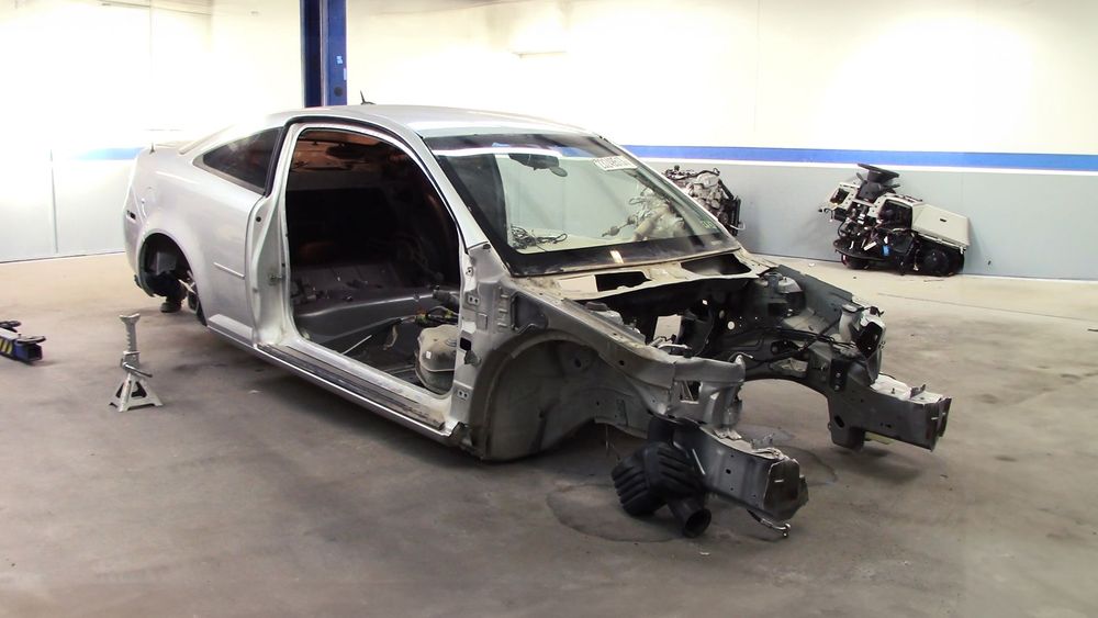 Fully stripped Cobalt donor on jack stands with donor parts removed
