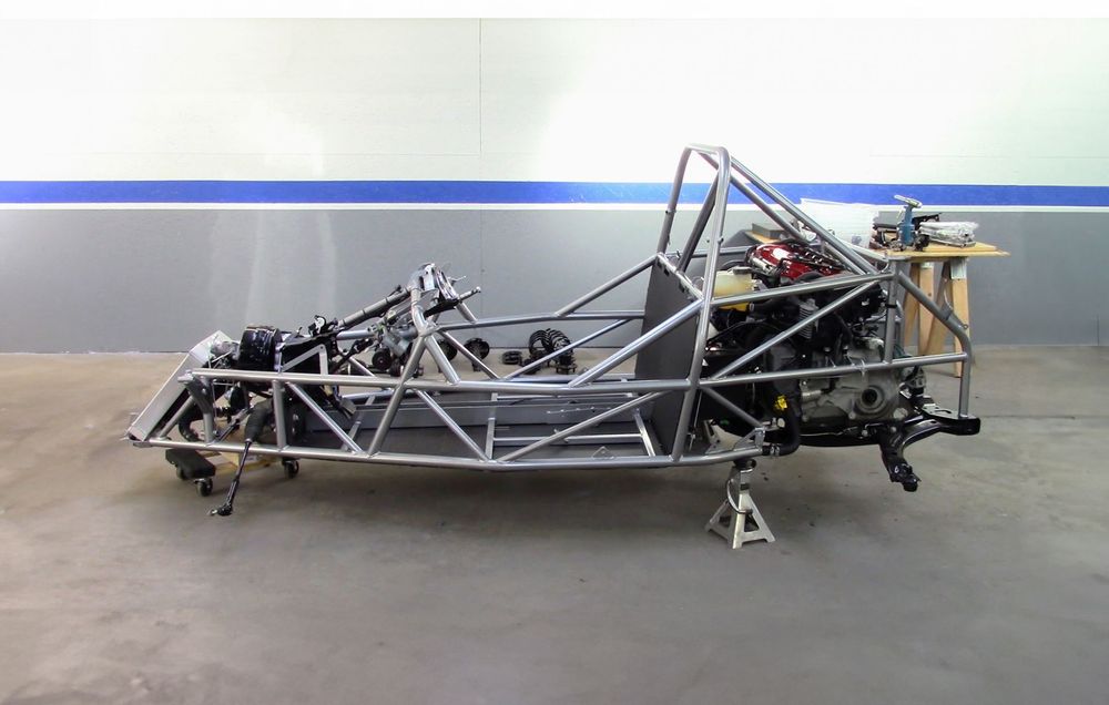 Goblin V1 chassis with engine, transmission, and subframe installed on stands