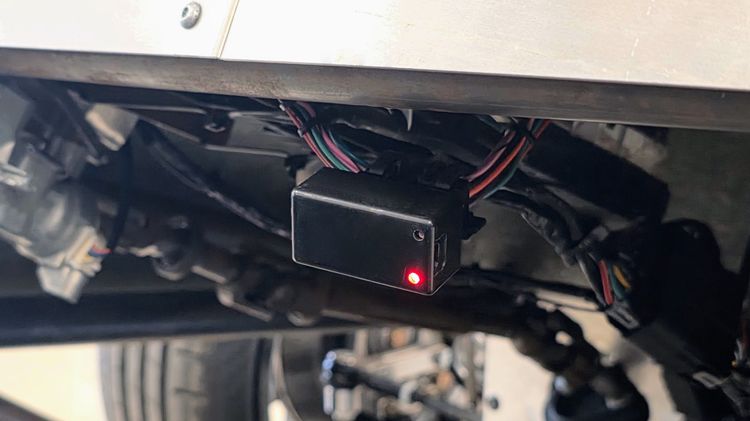 Macchina A0 Bluetooth OBD-II dongle plugged into the OBD-II port of a donor Mk7 GTI system, with the red status LED illuminated during the IMMO delete flash.