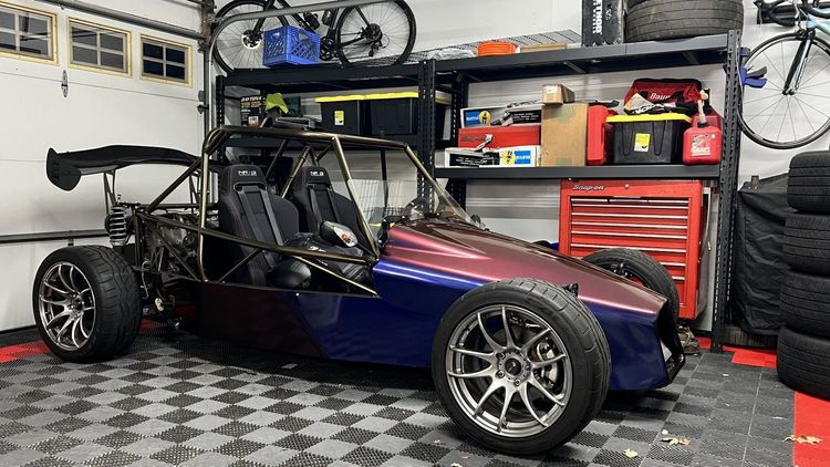 Finished Goblin #383 parked inside a garage with parts and tools stored neatly on vertical shelving.