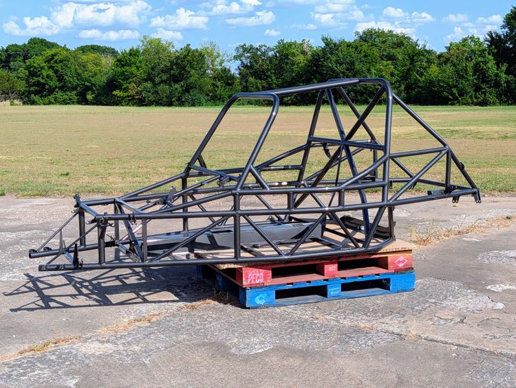 Goblin V2-006 chassis powder coated in Crystal Grey, sitting on a pallet outdoors, showing the T-Top main hoop, X-brace, and standard door bars