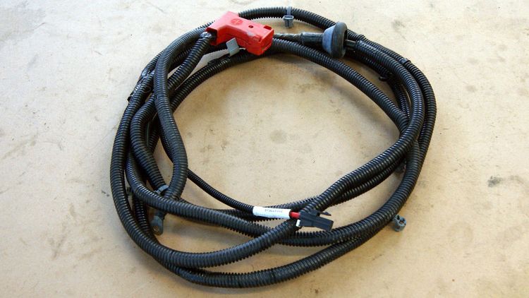 Large positive battery cable from a Chevrolet Cobalt donor, coiled with terminal connectors exposed.