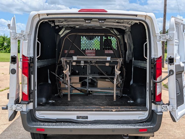 Goblin V1 exoskeletal chassis loaded inside a white Home Depot rental cargo van, viewed through the open rear doors