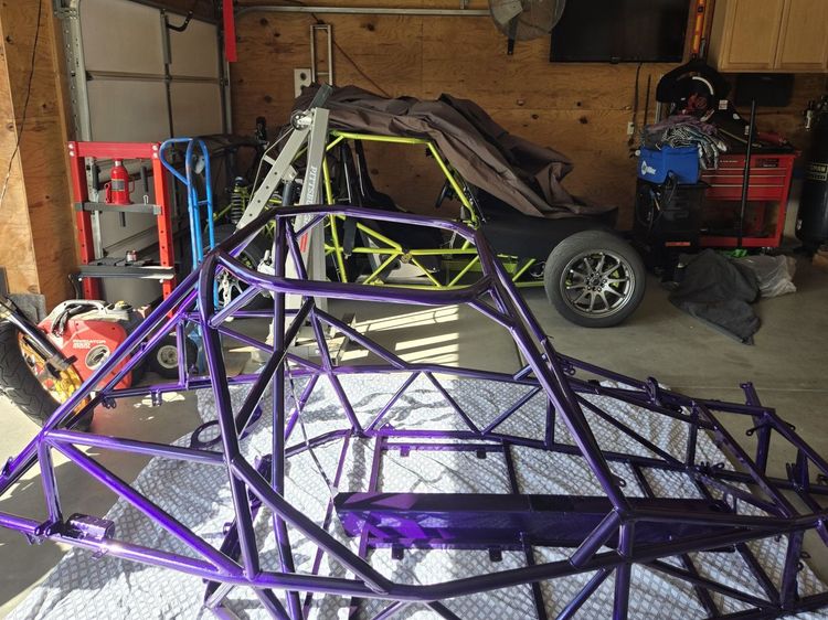 V2-001 Dirty Magic coated chassis with V1-135 finished in Illusion Shocker visible in the background.
