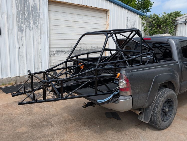 Goblin V2-002 chassis in gloss black powder coat, strapped down in the bed of a pickup truck after returning from powder coating.