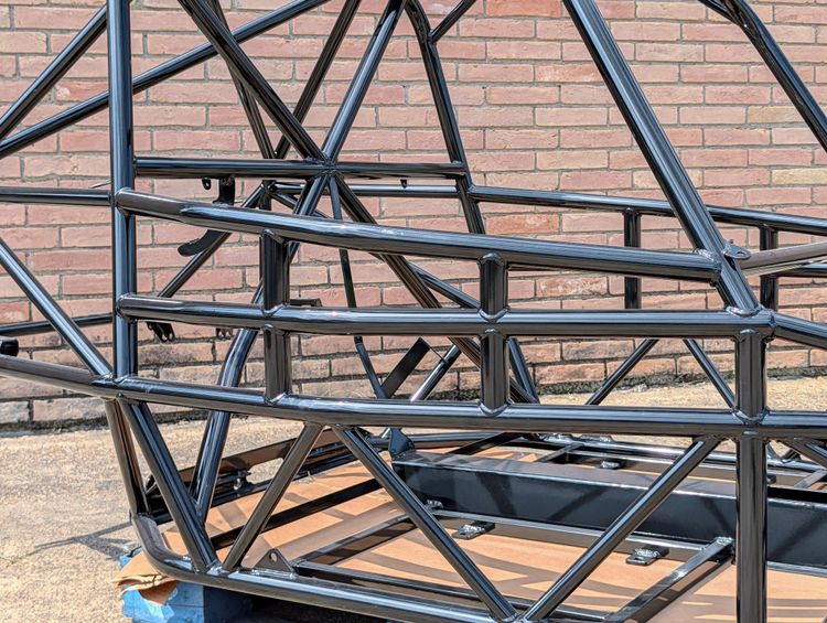 Close-up of the full containment door bars on Goblin V2-002 in gloss black, showing the additional horizontal tubes higher in the door opening for side intrusion protection.