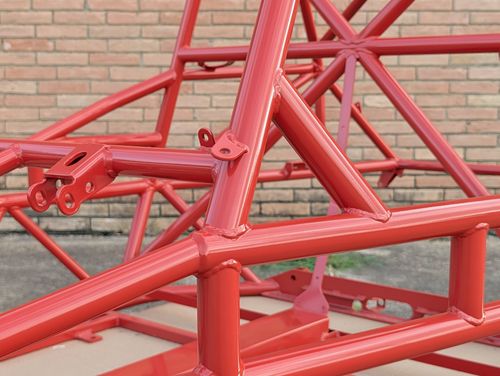 Close-up of the Goblin V2 standard door bar and dash bar junction, showing welded gussets and mounting tabs in Washed Red powder coat.